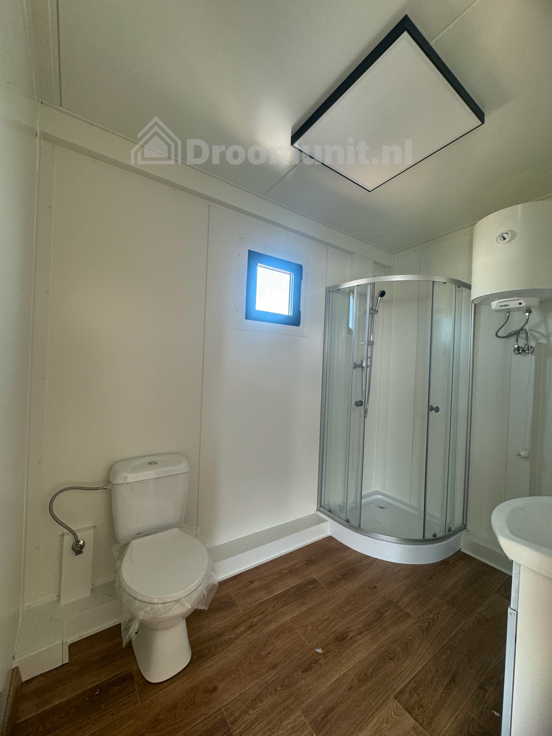 Badkamer met toilet en douchecabine in luxe mobiele prefab woonunit Emmy met 1 slaapkamer, afmeting 900x300