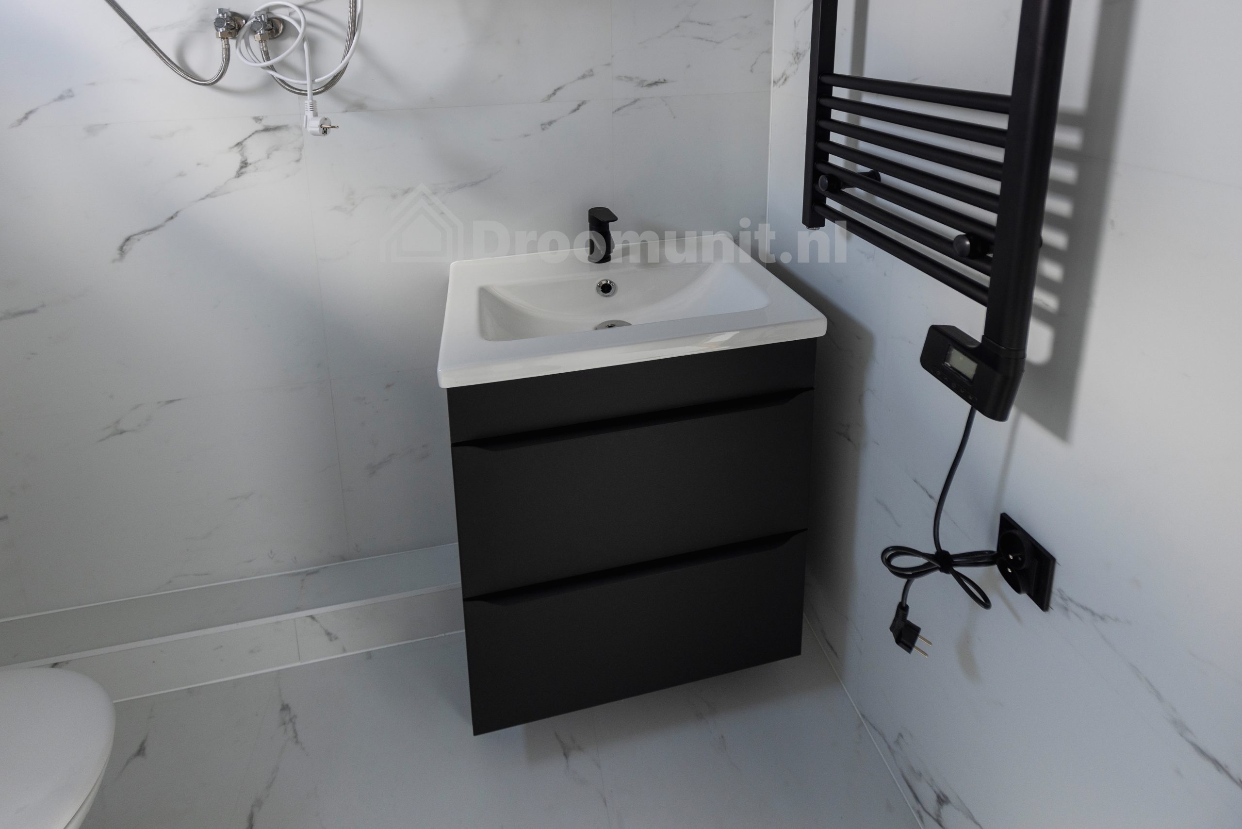 Badkamer met wastafel en verwarming in luxe mobiele prefab woonunit Emmy met 1 slaapkamer, afmeting 1100x300